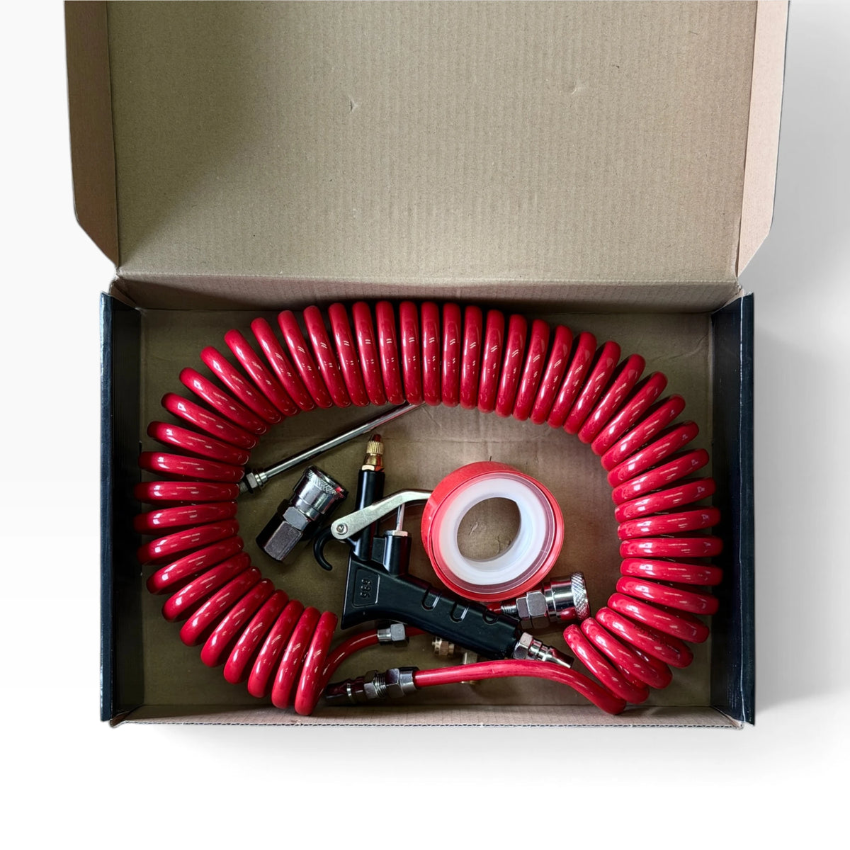 Air seat blow gun kit packed in its box: red coil hose, blow gun, fittings and thread-seal tape