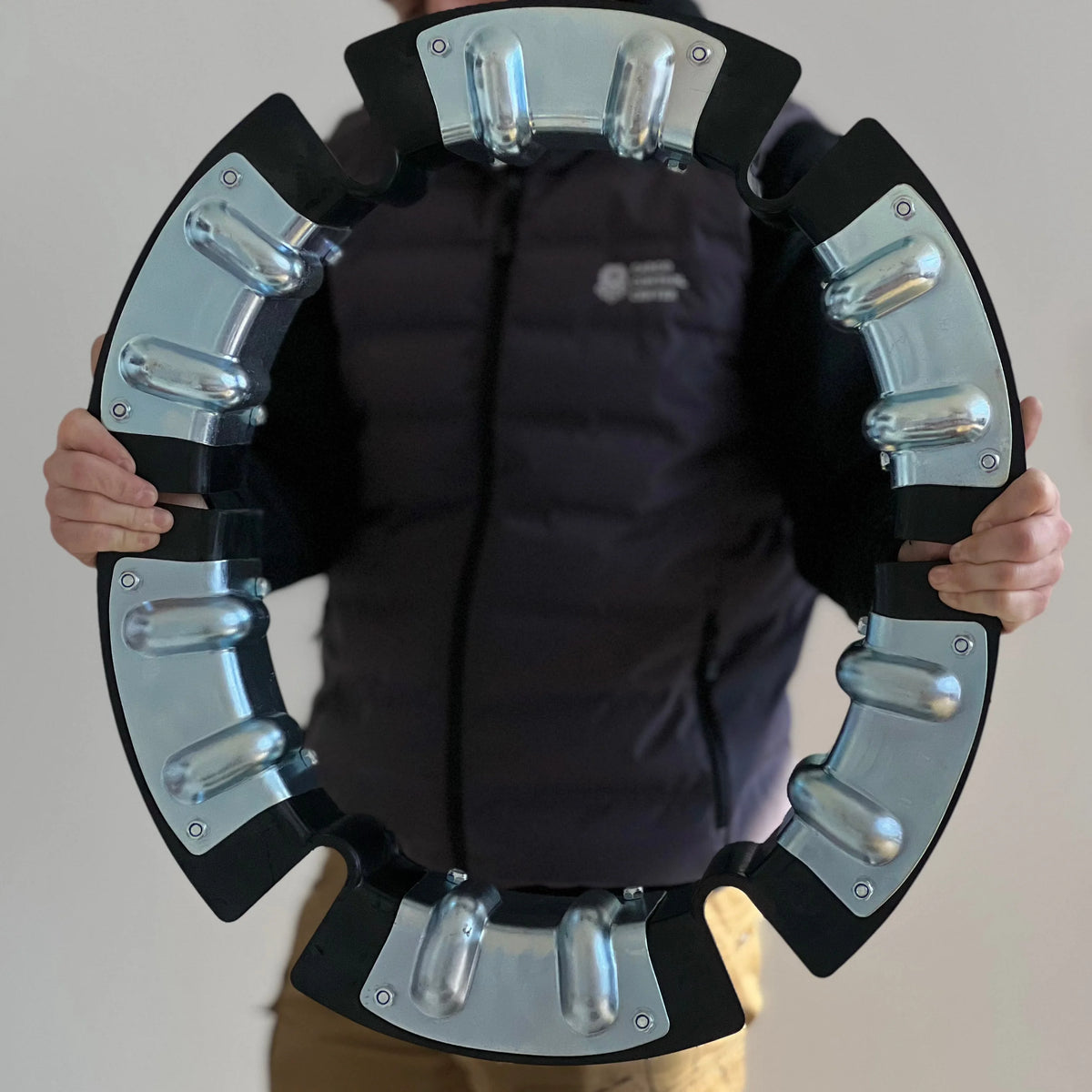 Coil protector assembled into a complete ring and held up by both hands