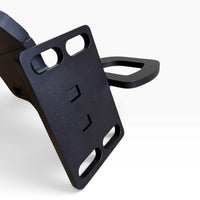 Close-up of a Cascadia deer guard bracket's mounting plate with its four slotted holes and the towing eye