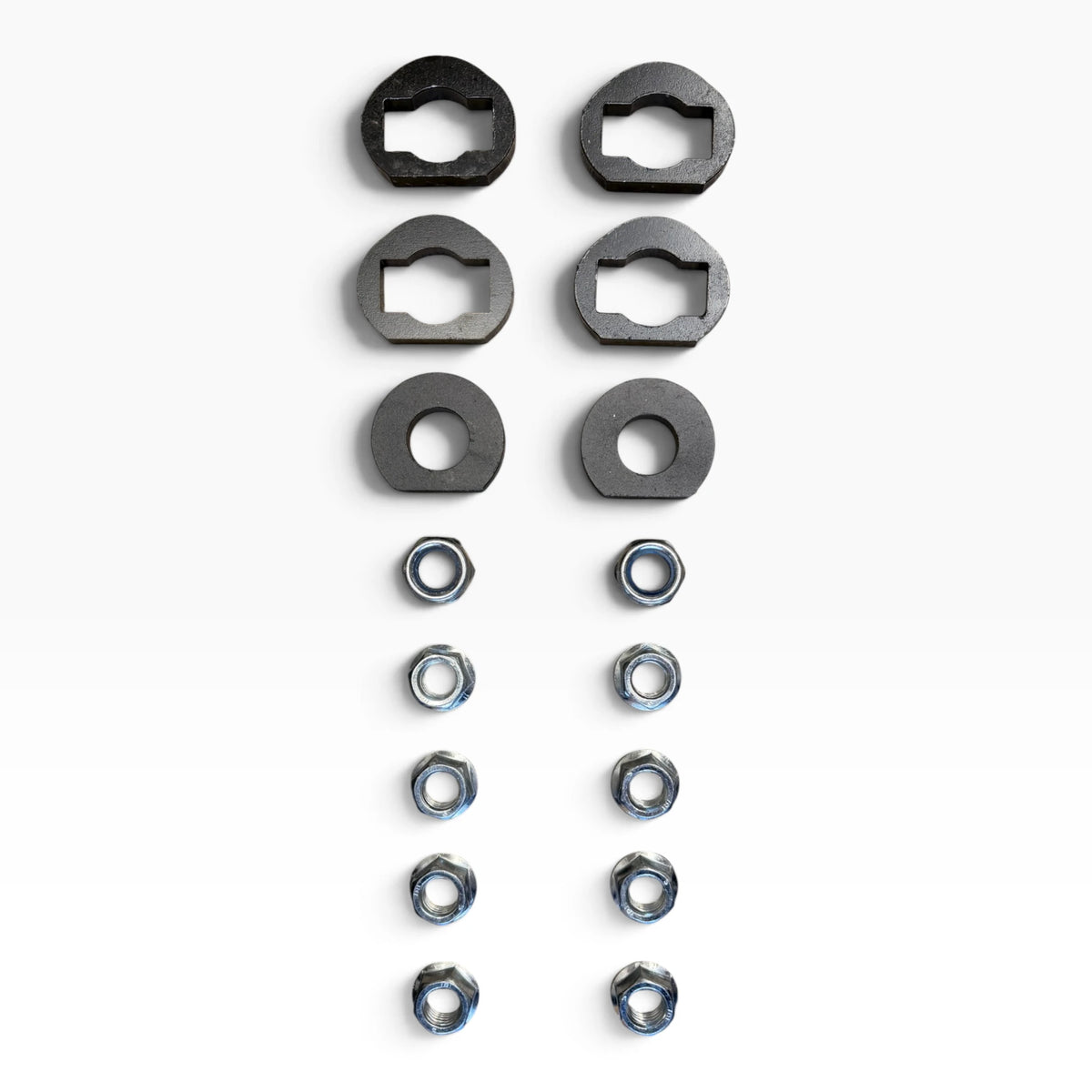 Hardware of the Cascadia 2026+ deer guard bracket set: four keyed plates, two round washers, two lock nuts and eight flange nuts