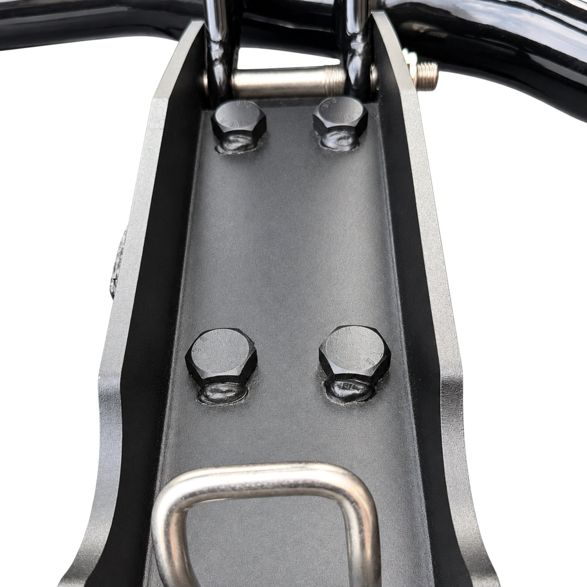 Close-up of the mounting plate on a deer guard post: four bolts and a U-bolt