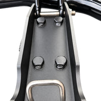 Close-up of the mounting plate on a deer guard post: four bolts and a U-bolt