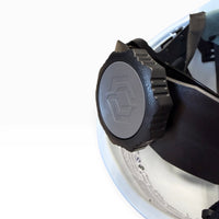 Close-up of the black adjustment knob at the back of the hard hat's suspension, with a hexagon logo on the dial.