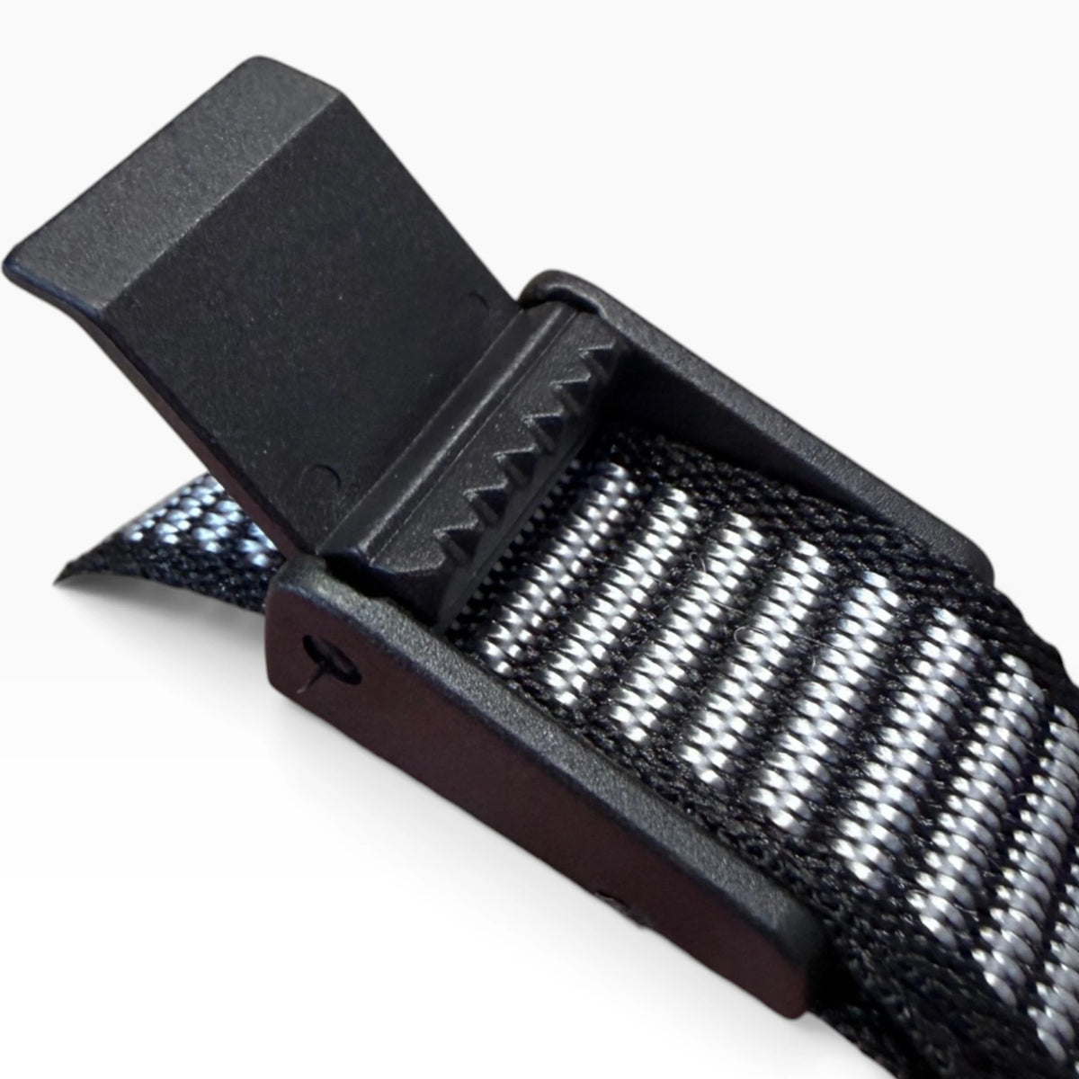 Close-up of the chin strap's toothed lever adjuster, flipped open, with the striped webbing running through it.