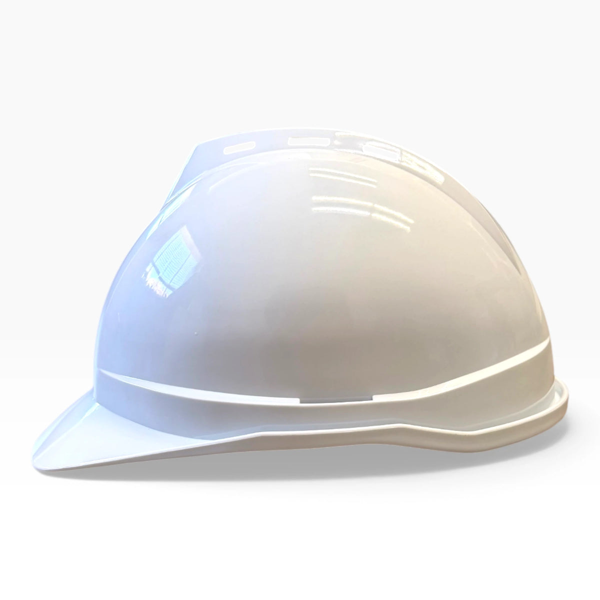 White hard hat in full side profile, showing the brim shape and the vent line along the crown.