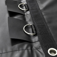 Close-up of the D-ring tie-down loops and grommets stitched along the black vinyl cover