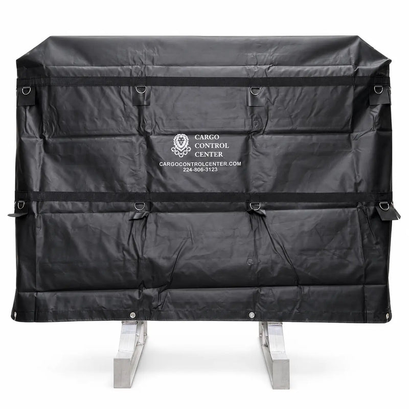 Black vinyl headache rack cover installed over the rack frame, front view showing the printed logo and D-ring tie-down points