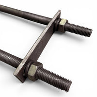 Close-up of one U-bolt's threaded legs, hex nuts and washers holding the flat mounting plate