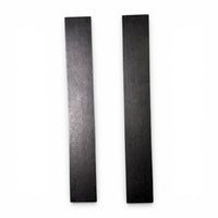 Two black rubber mounting pads laid side by side