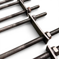 Close-up of several U-bolt threaded ends passing through their flat steel mounting plates