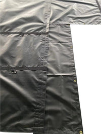 Black tarp's flap corner, showing the L-shaped seam, two D-ring tabs, and edge grommets