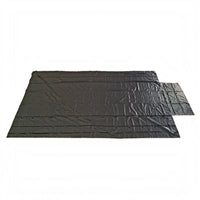 Black lumber tarp laid flat on white, seen from the long side with the end flap to the right and D-rings along both edges