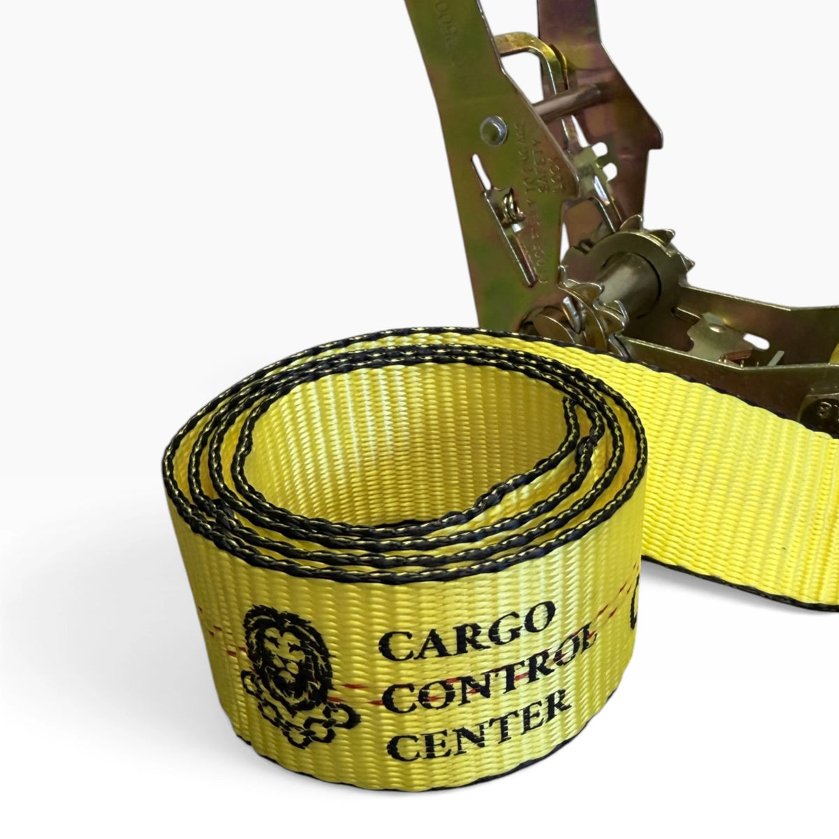 Coiled webbing showing the Cargo Control Center logo, with the ratchet in the background