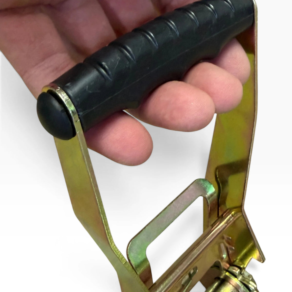 A hand gripping the black rubber ratchet handle, showing the size of the lever.