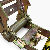 Macro view of the open ratchet showing the spindle, spring-loaded pawl and gear teeth.