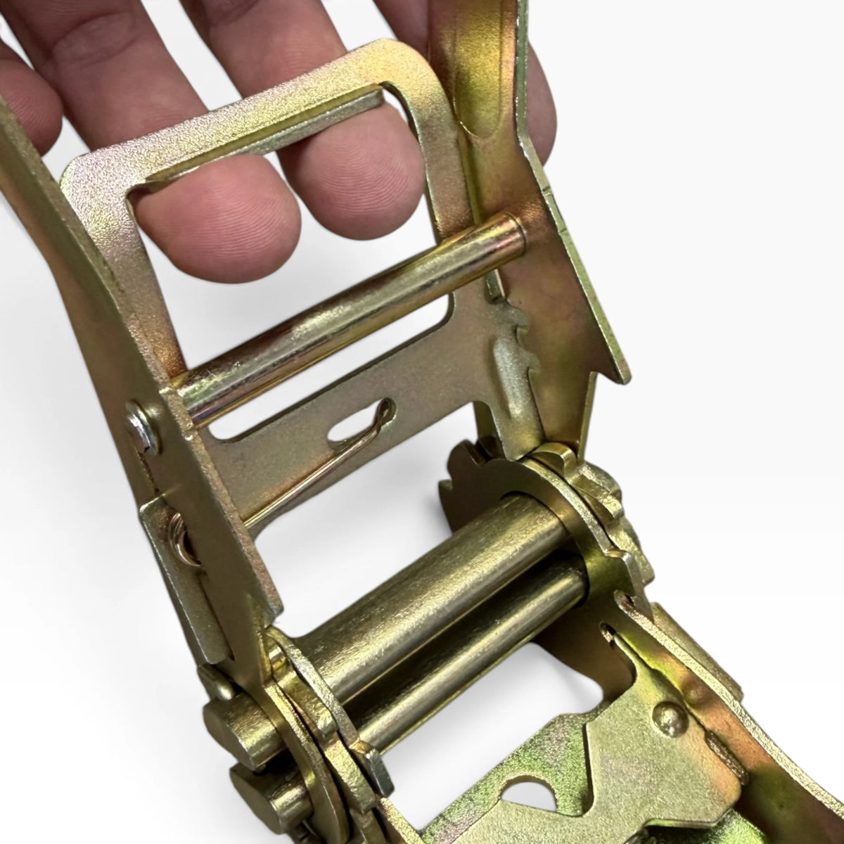 Hand holding the long ratchet handle open, fingers through the wide metal grip frame.