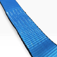 Macro view of the blue polyester webbing weave with dark stitched edges.