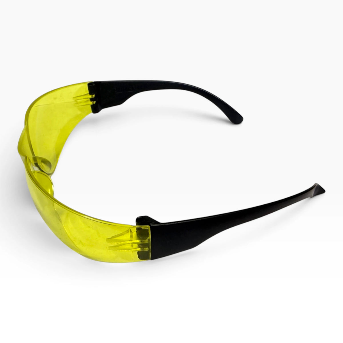 Yellow-lens safety glasses viewed from behind at an angle, showing both black temple arms.