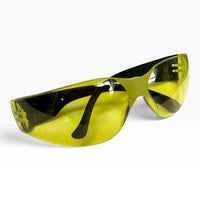Yellow-lens safety glasses at a three-quarter angle with both black temple arms folded behind the lens.