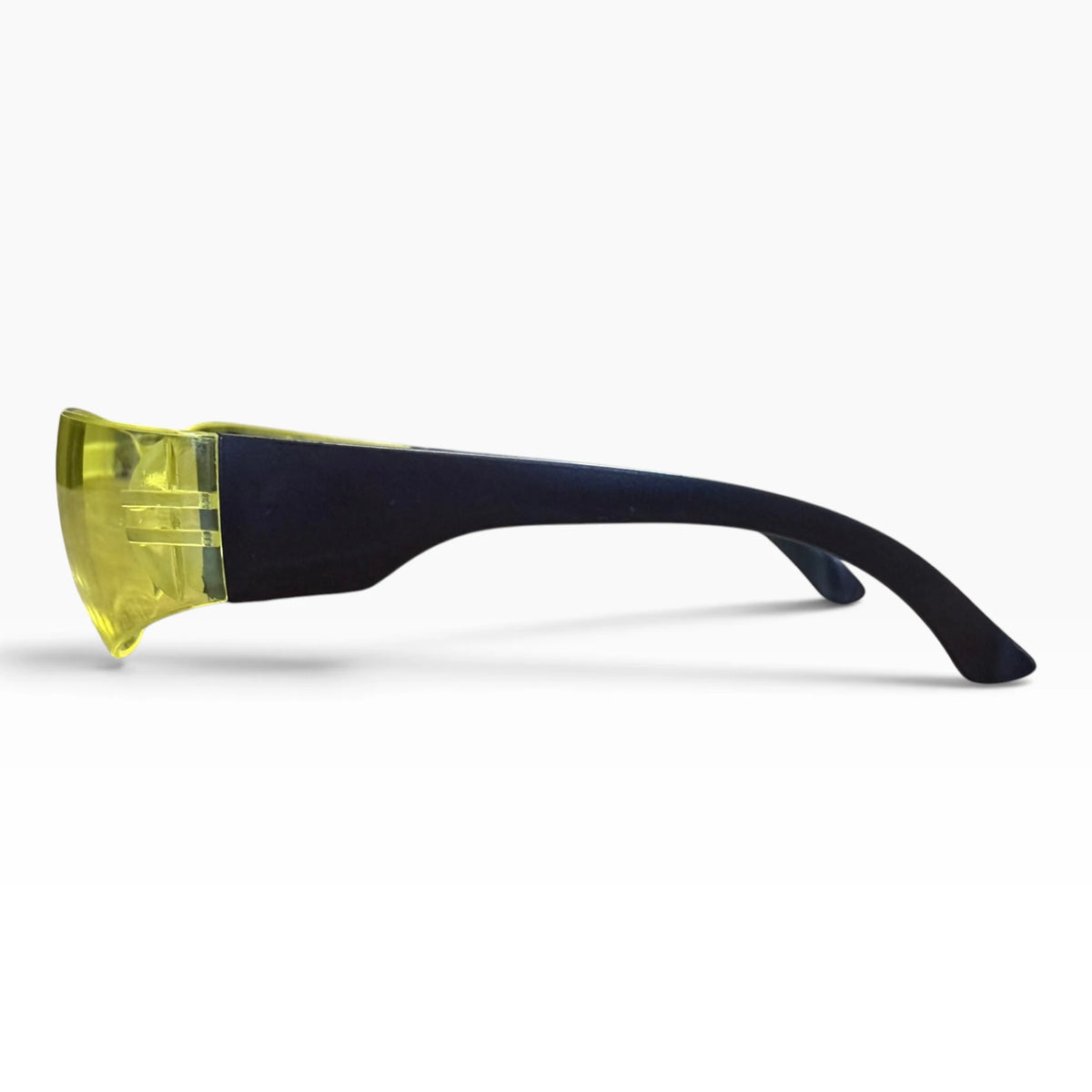 Side profile of yellow-lens safety glasses with the black temple arm extended.