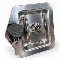 T-handle lock at an angle with the rubber cap swung open and the keys in the cylinder