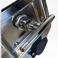 Close-up of the chrome T-handle lifted out of the stainless dish on its swivel
