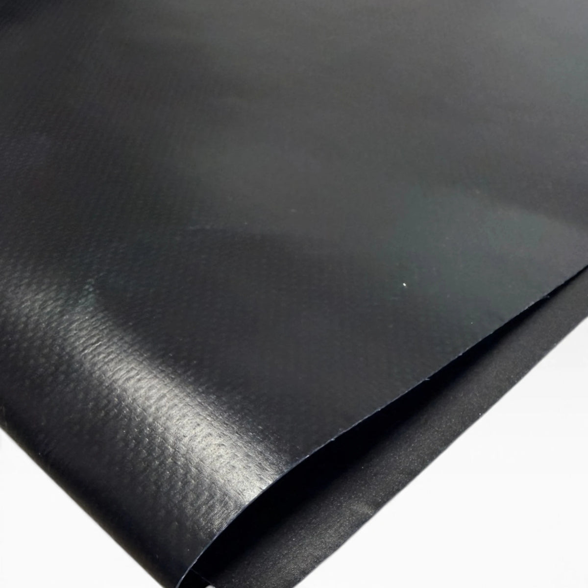 Close-up of the black vinyl patch surface with one edge folded over