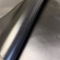 Patch material folded to show its glossy side against its matte side