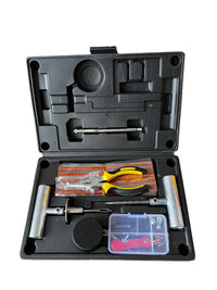 Tire repair kit case open, showing plug strips, pliers, insertion tools, and a parts tray