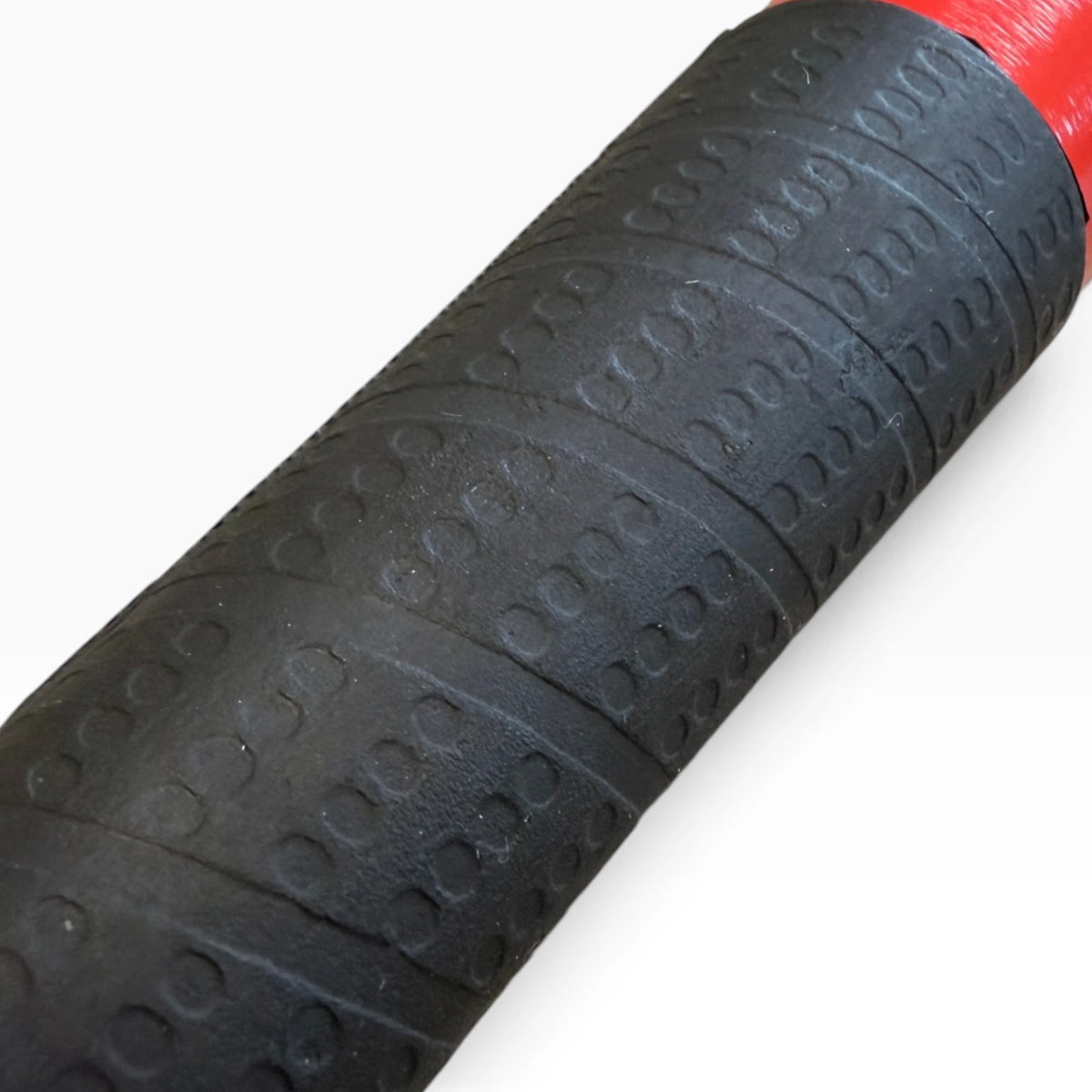 Close-up of the textured black rubber grip wrapped around the tire thumper handle