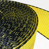 Macro of the tightly wound coil showing black edge yarns and the woven yellow webbing