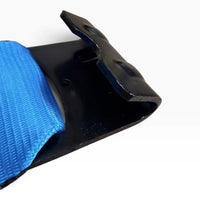 Overhead close-up of the black flat hook plate with stiffening ribs and webbing entering the slot.