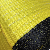 Extreme close-up of the yellow weave with white tracer threads beside the dark coiled layers.