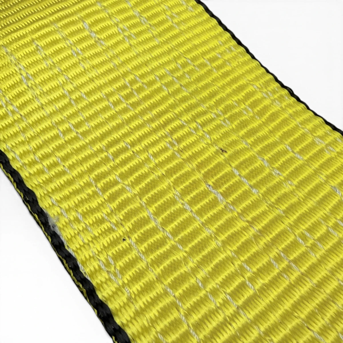 Close-up of the yellow polyester weave with white tracer threads and a black stitched edge
