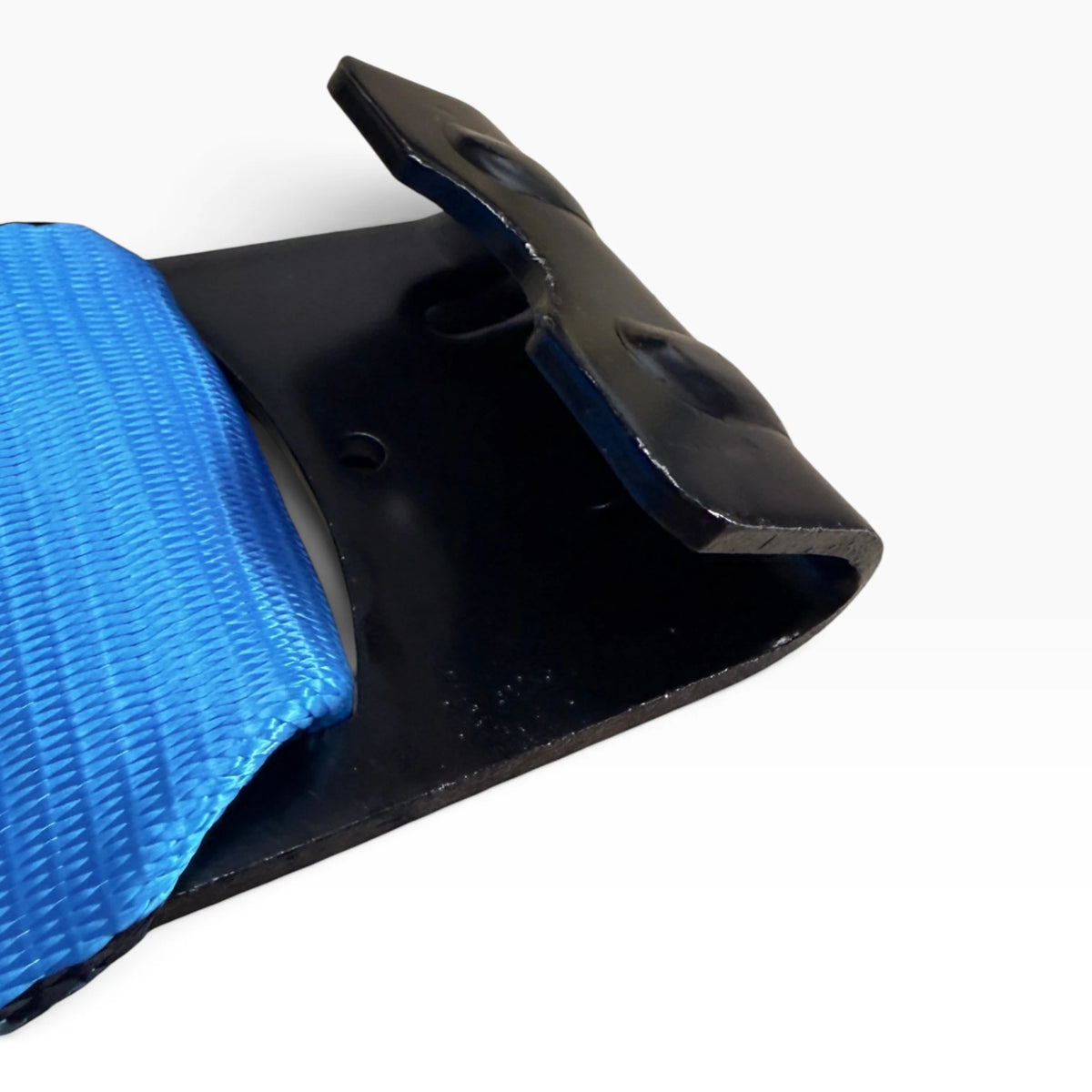 Overhead close-up of the black flat hook plate with reinforcing ribs and webbing entering the slot.