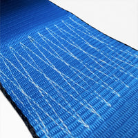 Extreme close-up of blue webbing showing the woven fabric and diagonal white stitching lines.