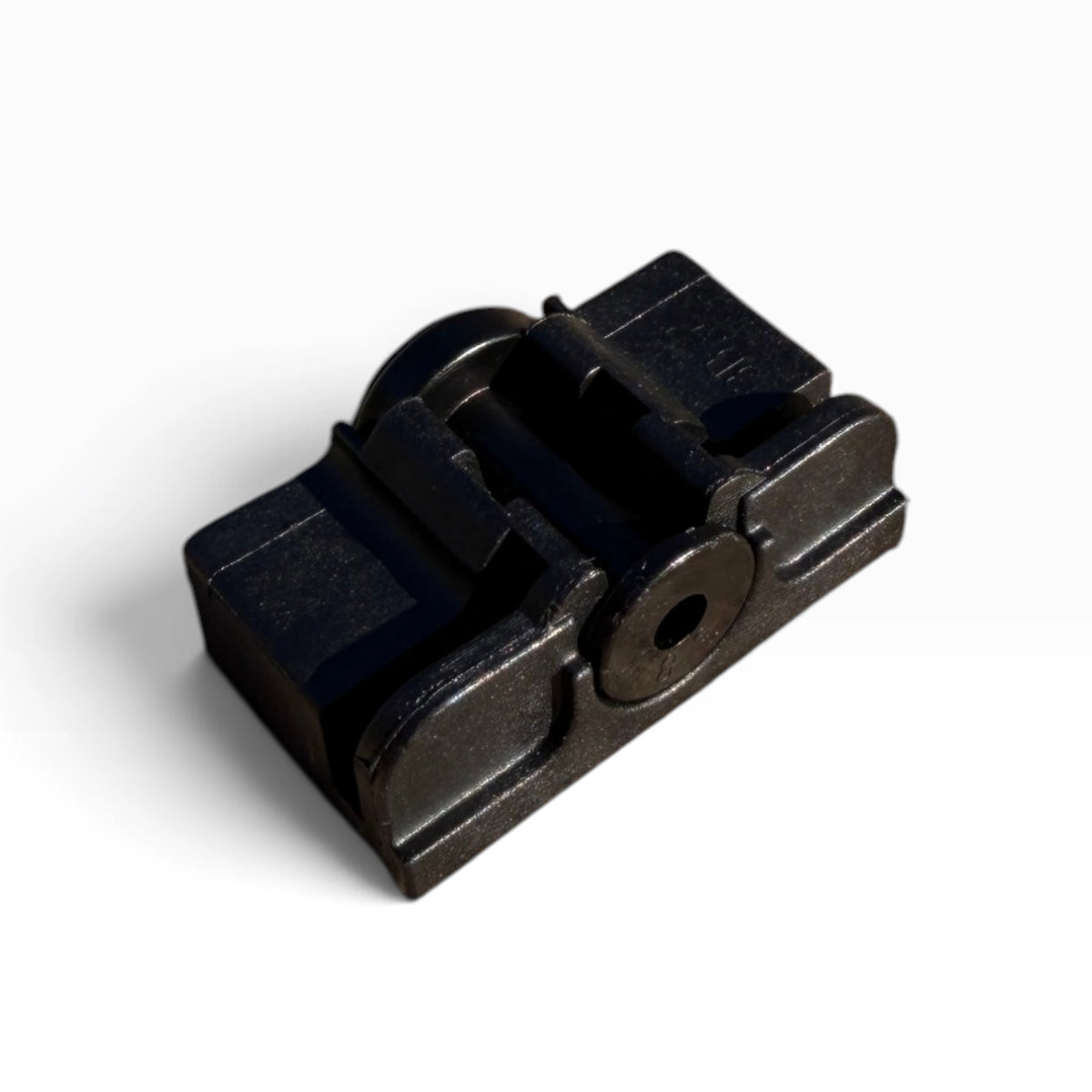 Close-up of the wiper blade's adapter base showing its center pivot hole and side grooves