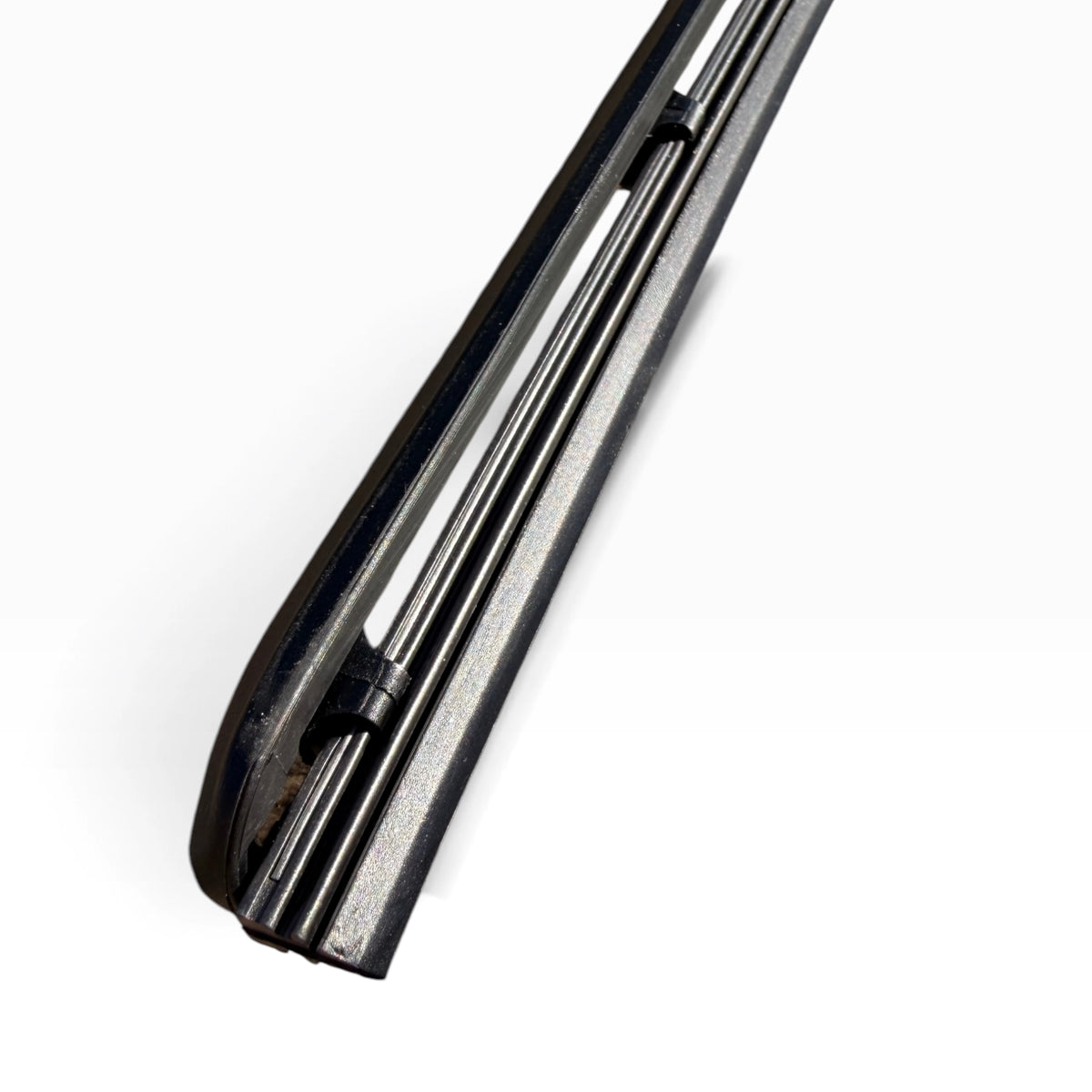 Close-up of the dual rubber refill strips inside the wiper blade frame near the tip